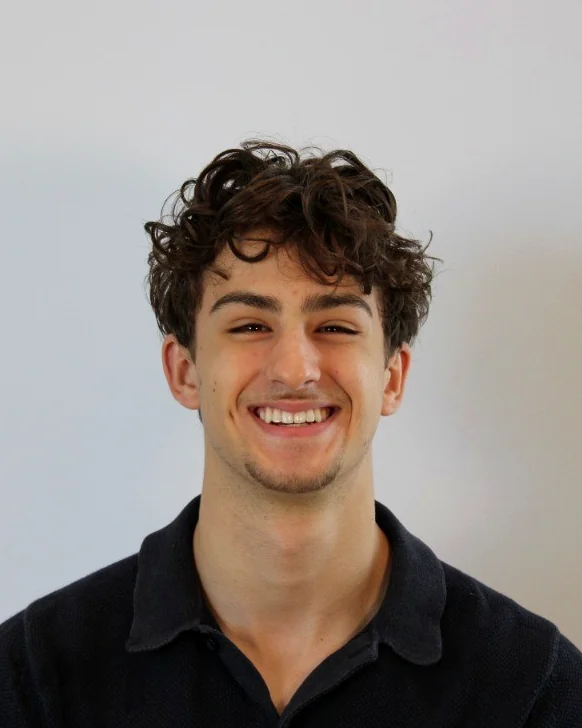 Zach Holbrook, founder of DoubtFree, smiling in a dark polo shirt